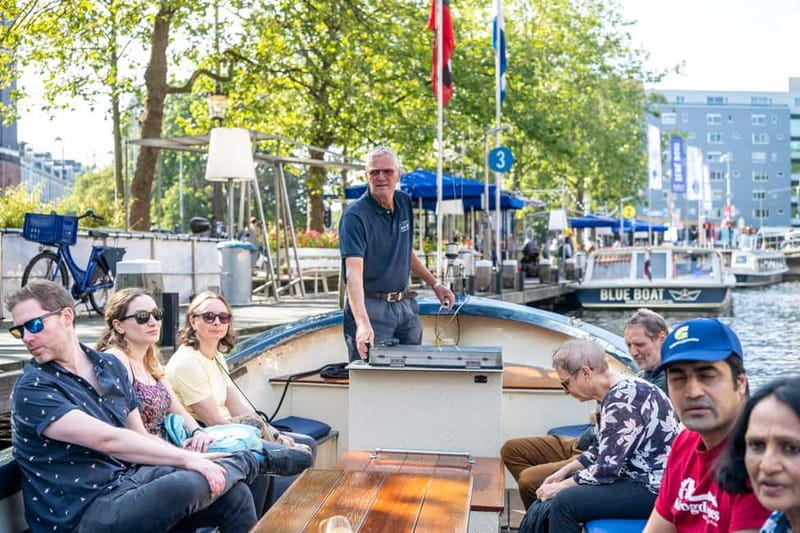 Amsterdam: 75 minute Open Boat Canal Cruise with Live Guide - The opening sights around the city center