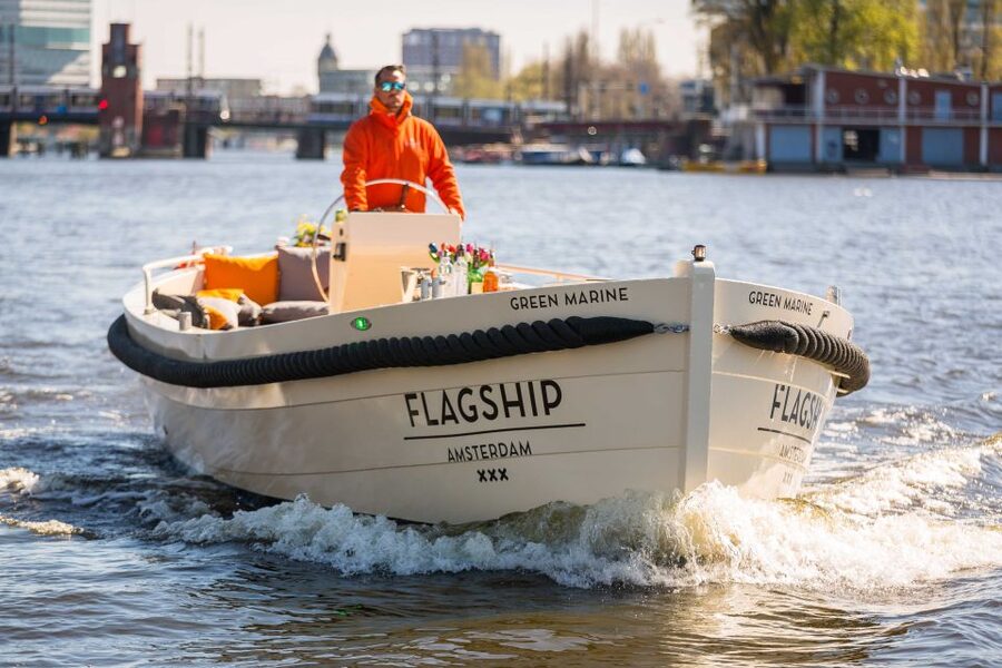 Amsterdam: Canal Belt Private Beer Boat Tour - An open-top boat with a social layout