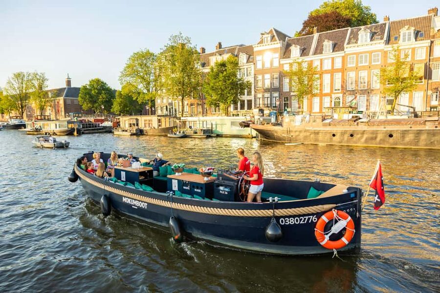 Amsterdam: Guided Open Boat Canal Cruise Including Drink - The canal belt, seven bridges, and grand houses