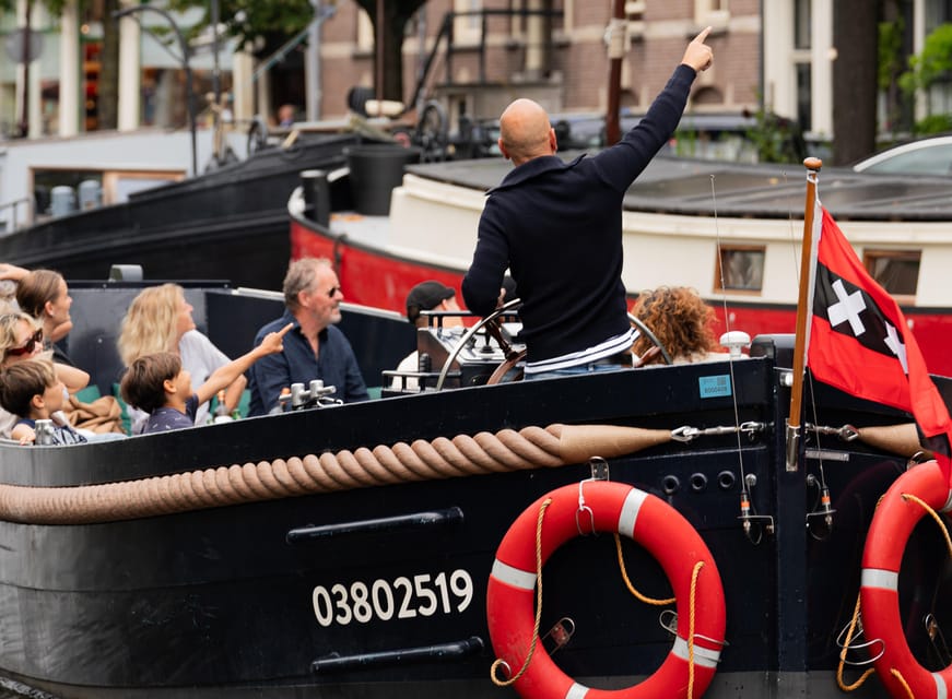 Amsterdam: Guided Open Boat Canal Cruise Including Drink - Historic houses and the return to the station