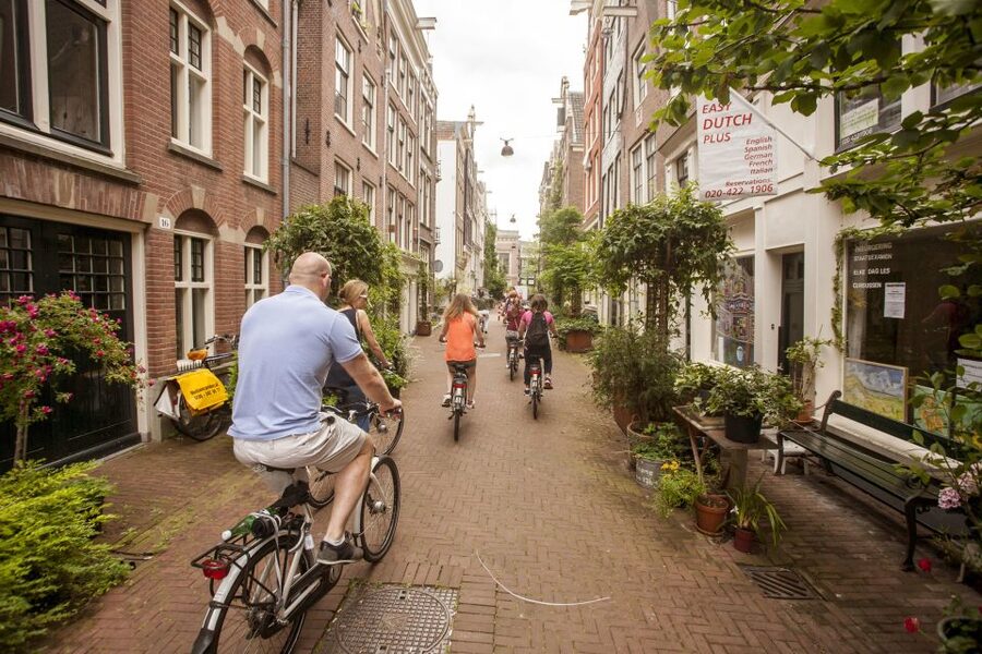 Amsterdam: Hidden Gems & Highlights Guided Bike Tour - Bikes, helmets, and city safety