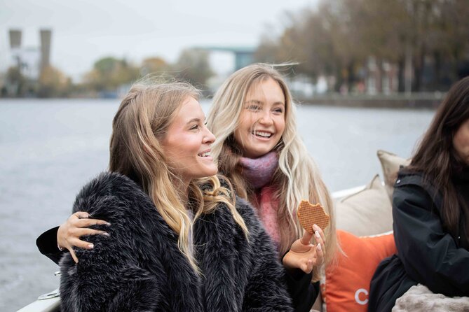 Amsterdam: Luxury Saloon Boat Cruise with Cocktails & Waffle - Central Station, the Kolksluice, and the working waterfront