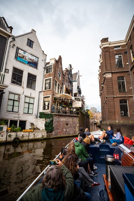 Amsterdam:Old City Canal Cruise with Live Guide and Open Bar - Bridges, Houseboats, and the Magere Brug