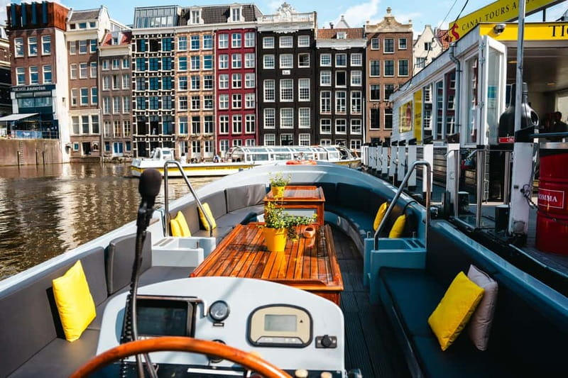Amsterdam: Open Boat Tour of Canals with Expert Local Guide - Gliding under Magere Brug