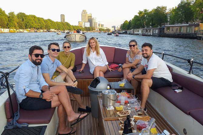 Guided Amsterdam Canal Cruise – Snacks & Drinks on board(1 Hour) - Starting among Amsterdam’s oldest canals