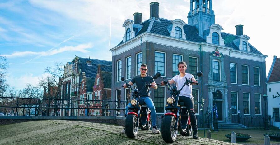Volendam: E-Scooter Rental - Monnickendam’s harbor and brick houses